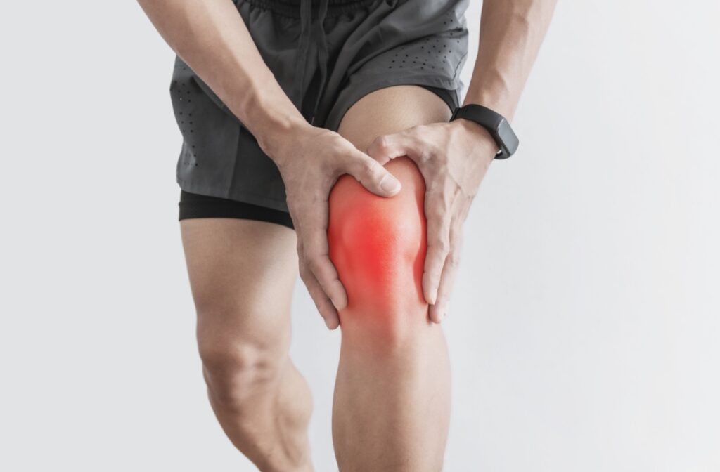 A man holding his knee due to severe pain
