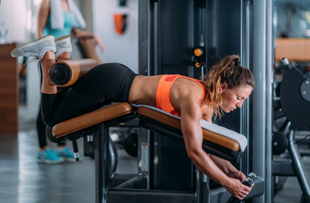 A person at the gym doing leg curls to strengthen their hamstrings.