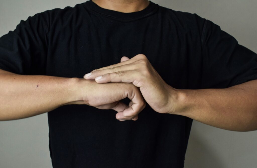Close up of a person's hands while they crack their knuckles
